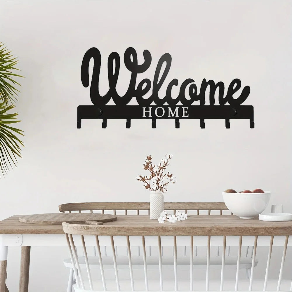 Black decorative metal key holder rack with hooks spelling out Welcome Home