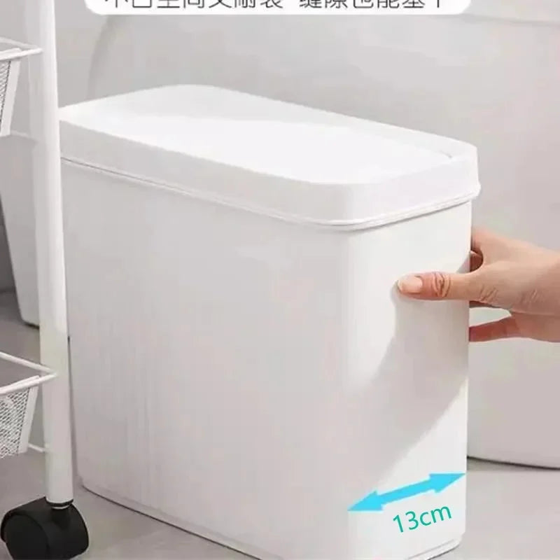 A white slim bathroom trash can with a press lid is shown being held by a hand, displaying a 13cm measurement.