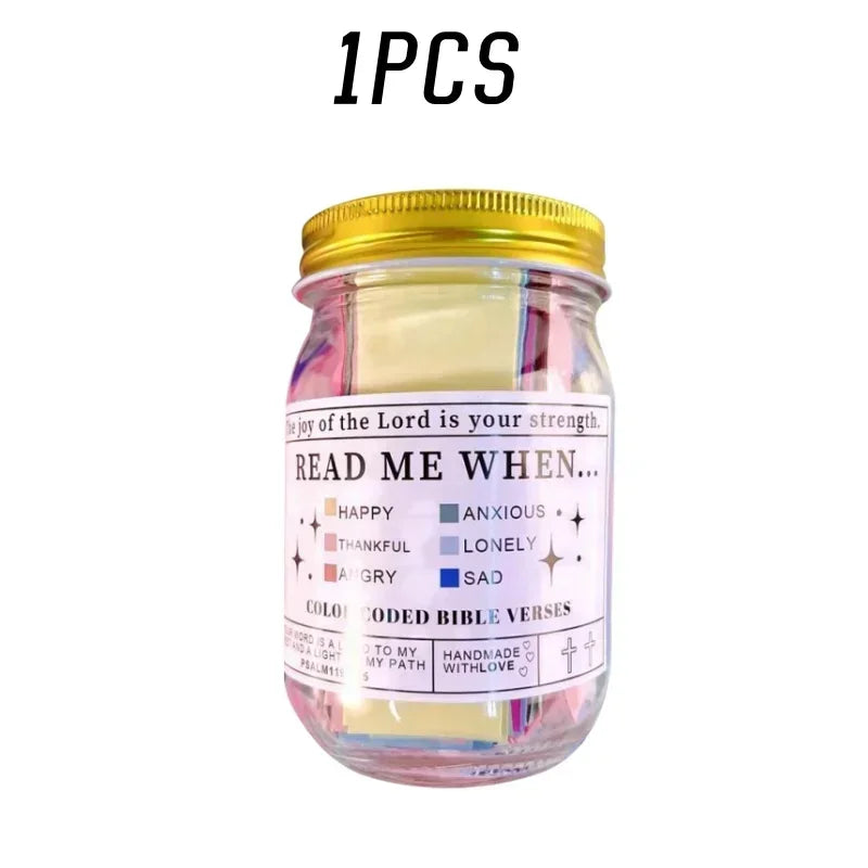A glass jar filled with colorful scripture verses and sealed with a gold lid.