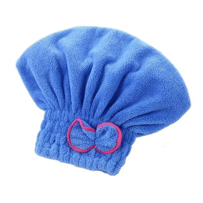 A bright blue microfiber hair drying towel cap with a gathered top and a pink drawstring detail.