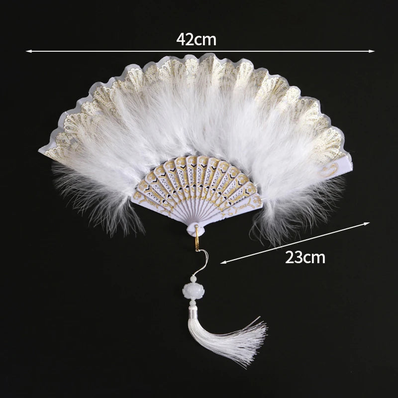 White lace fabric folding hand fan with gold accents and a decorative tassel