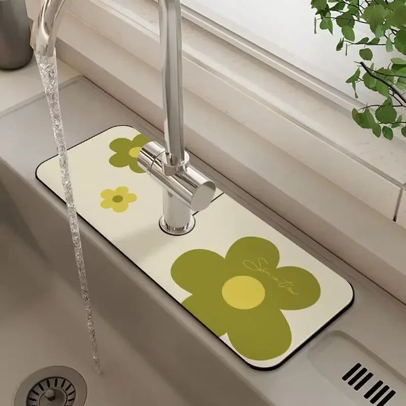 A yellow flower-patterned faucet mat is placed on a sink, with a chrome faucet and a clear water stream visible.