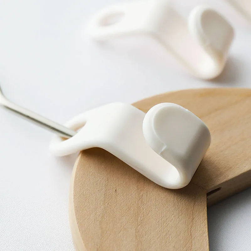 A white plastic clothes hanger hook is shown attached to a wooden hanger for wardrobe organization.
