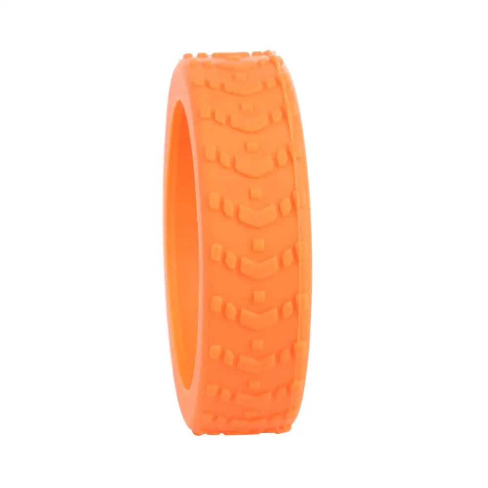 An orange silicone luggage wheel protector with textured grip.
