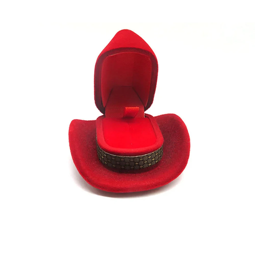 A red velvet cowboy hat jewelry storage box with a felt lining and a textured black band.