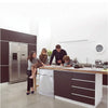 A silver washing machine cover is displayed on a kitchen countertop in a modern, bright room.