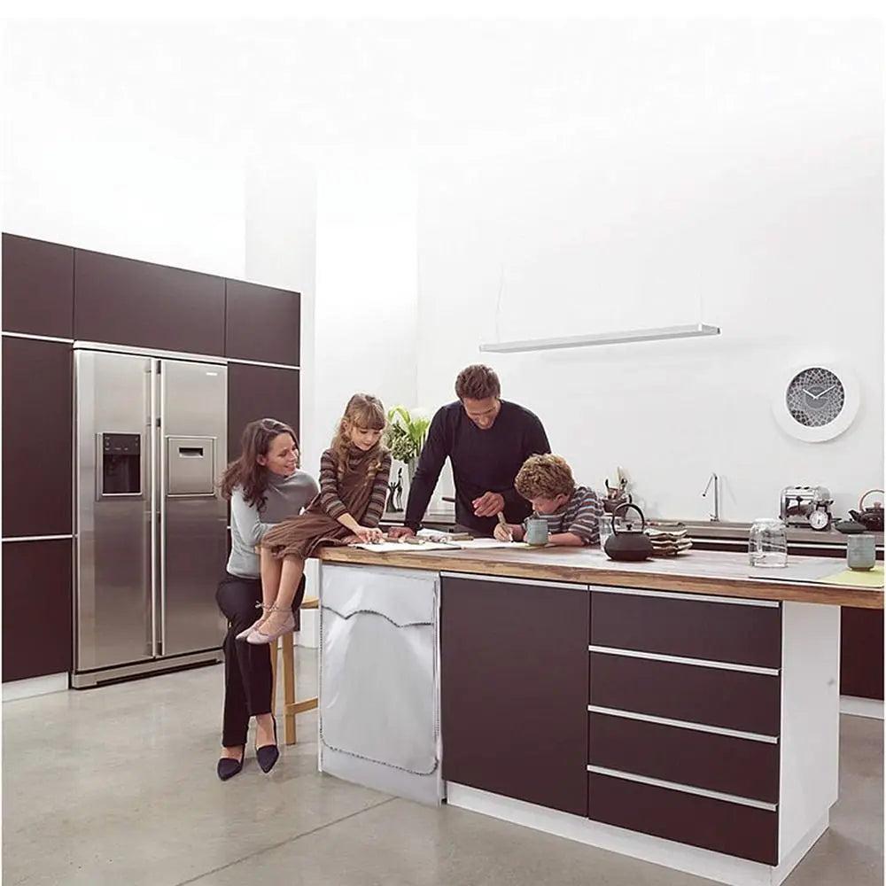 A silver washing machine cover is displayed on a kitchen countertop in a modern, bright room.