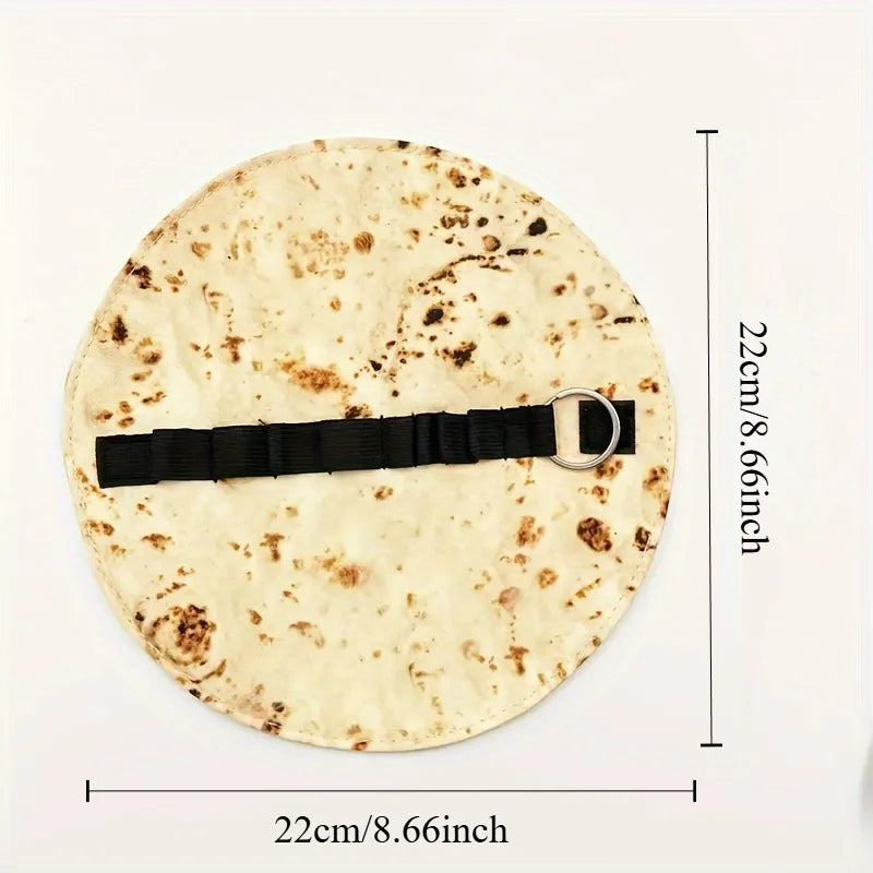 A round canvas pencil pouch featuring a burrito design and secured with a black strap.