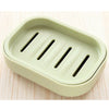A light green double layer drain soap dish with three slots for draining soap.