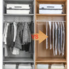 A storage cabinet showing hanging vacuum storage bags for clothing and folded textiles.