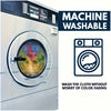 A close-up of a stainless steel washing machine door with a label indicating the machine is washable and safe for color-fadin