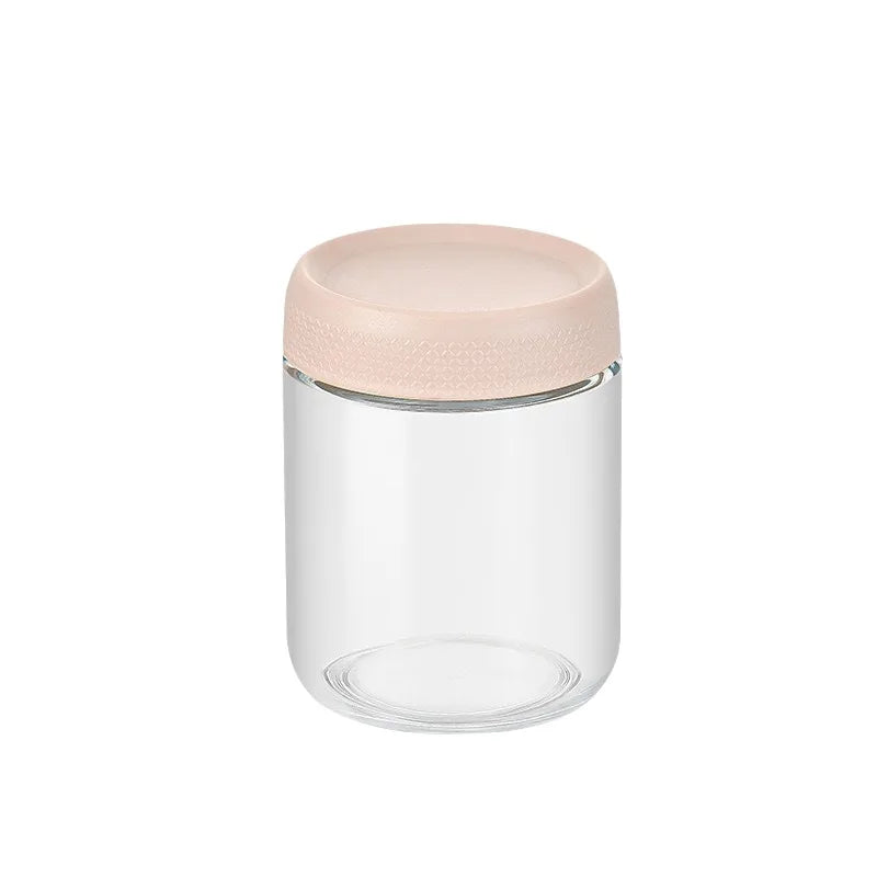 A clear glass meal prep jar with a light pink, airtight lid.
