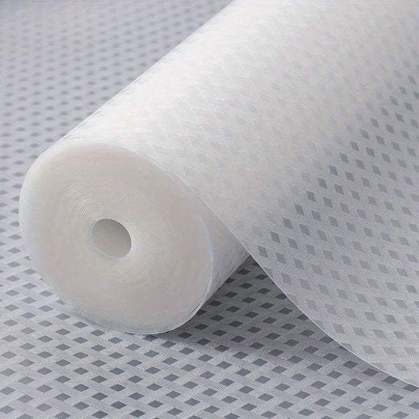 Roll of white reusable shelf liner material with a grid pattern on a gray surface.