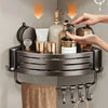A triangular suction cup storage shelf holding various toiletries and a towel on a wall.