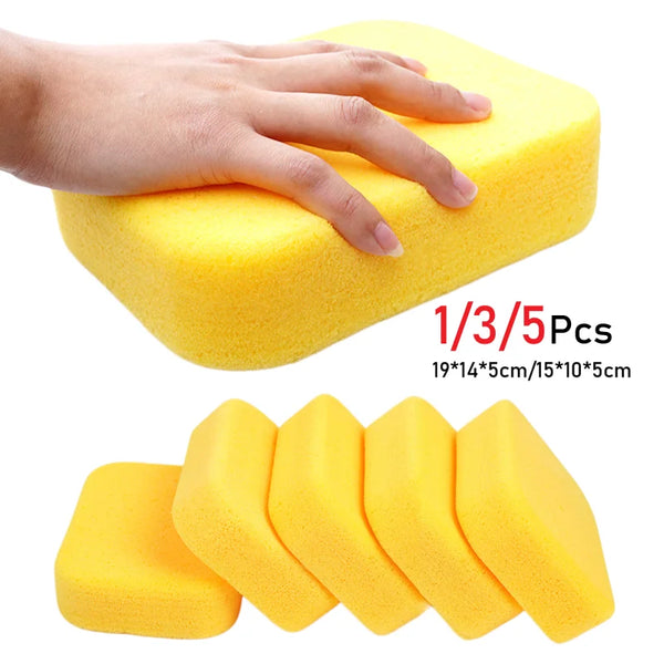 A hand is squeezing a yellow car wash sponge set for auto care, showing five individual sponges.