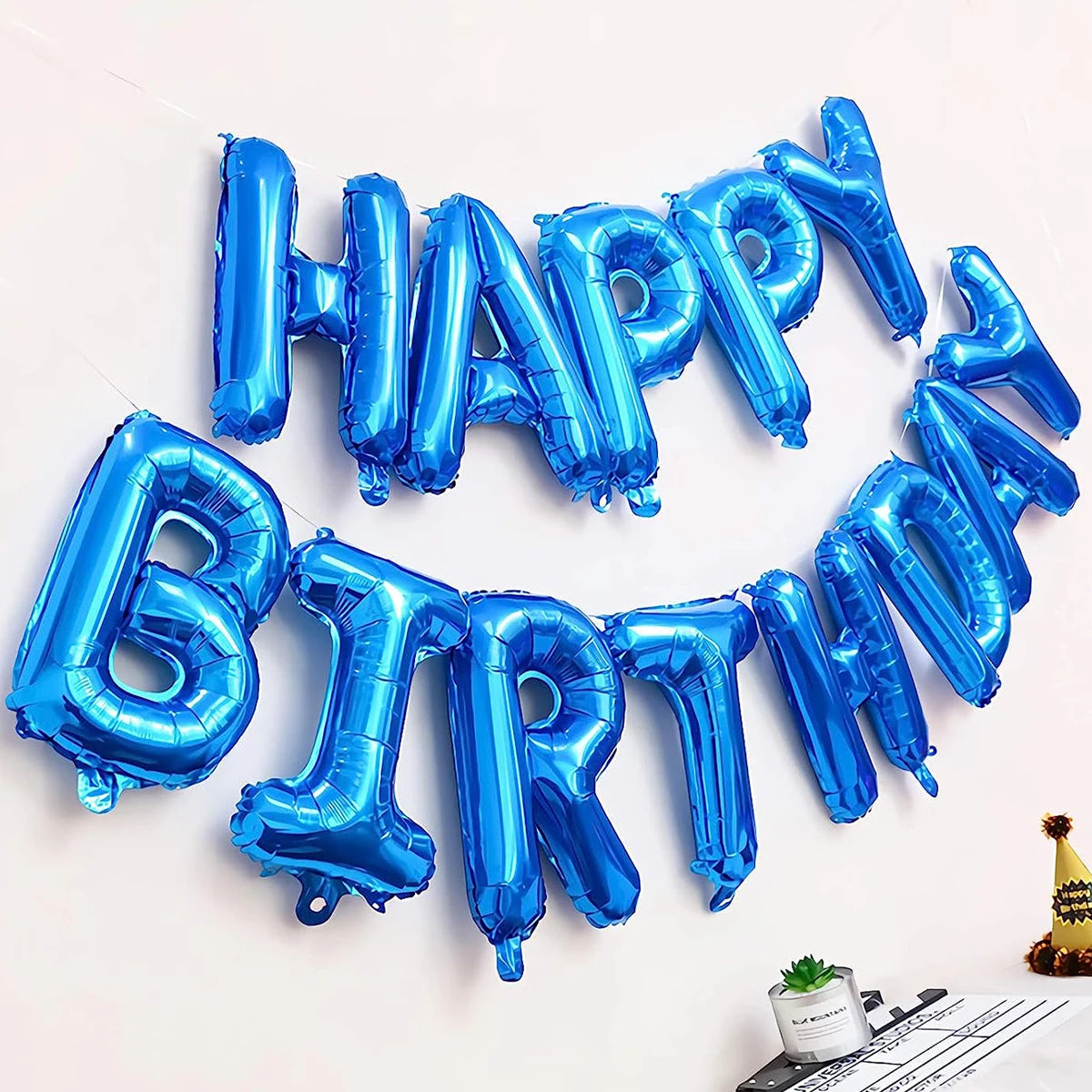 A circular arrangement of blue foil balloons spelling out HAPPY BIRTHDAY
