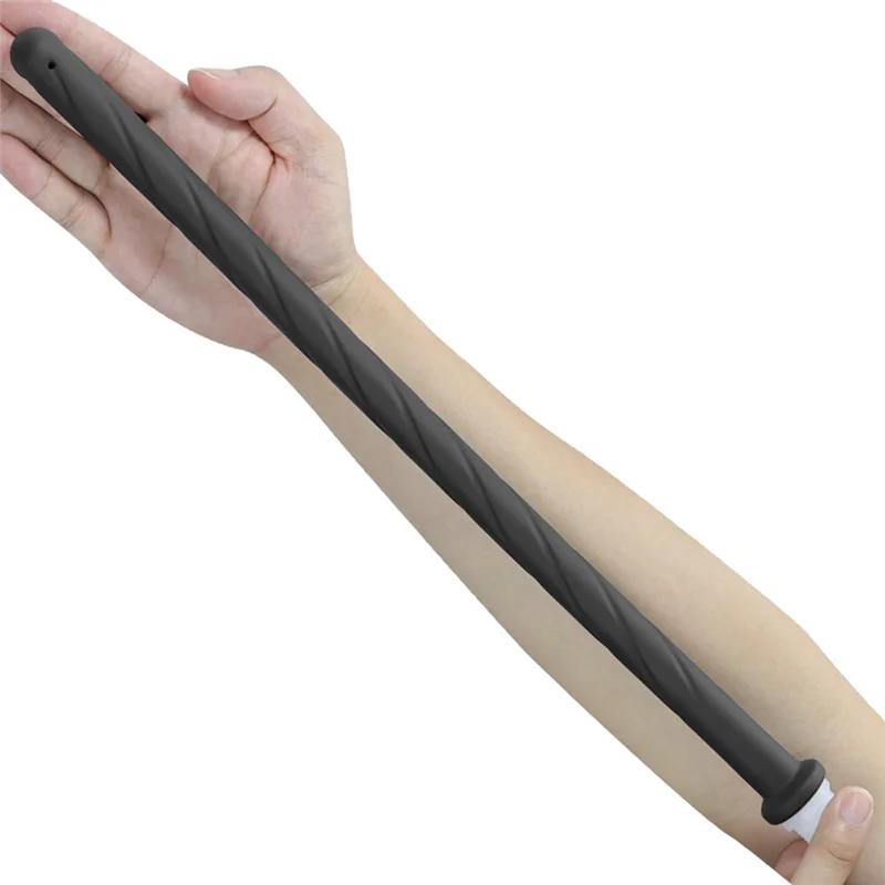 A hand is holding a black handheld bidet sprayer with a silicone hose.