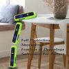 A collection of bright lime green silicone remote control covers with lanyards displayed on a wooden table.