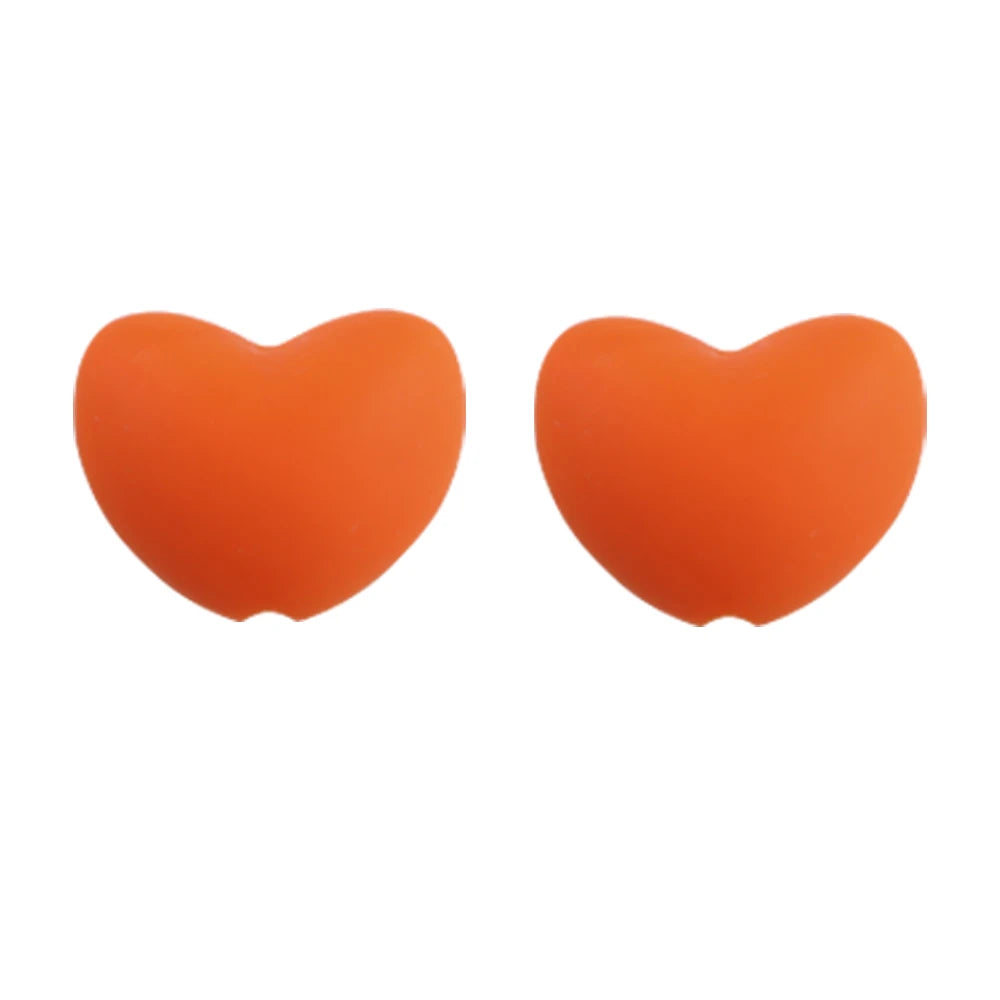 A pair of bright orange heart-shaped silicone charm beads for DIY jewelry.