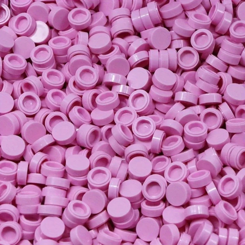 A pile of round pink building blocks for DIY projects.