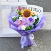 A purple handmade crochet flower bouquet featuring various textured flowers and greenery.