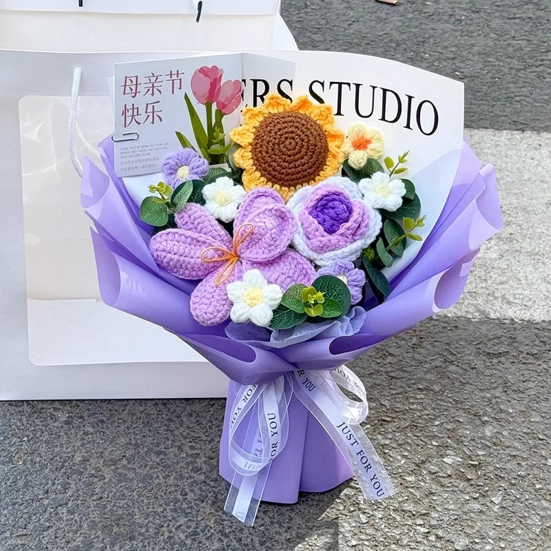 A purple handmade crochet flower bouquet featuring various textured flowers and greenery.