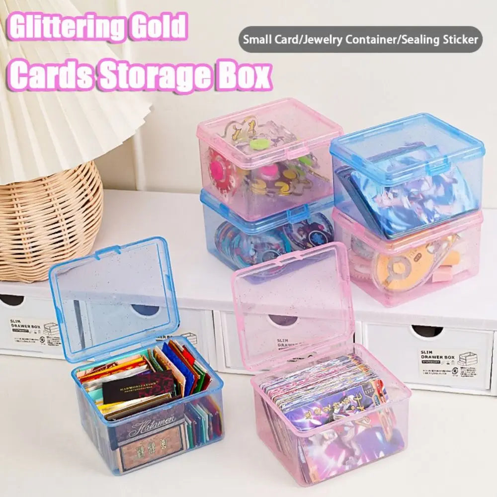 A collection of glittering gold cards stored in clear plastic storage boxes for jewelry and small items