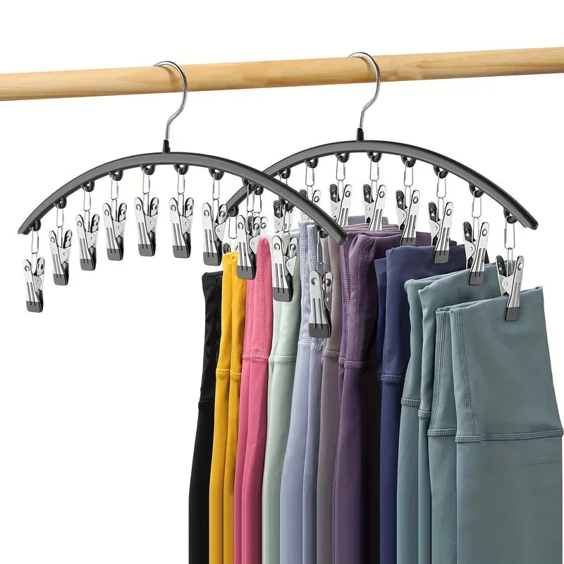 Curved metal hangers with ten clips used to organize clothing on a wooden rod.