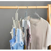 A multi-layer storage hanger bag organizer with various colored hangers hanging on a wooden rack.