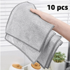 A hand is holding a stack of ten gray non-stick wire cleaning dish rags.