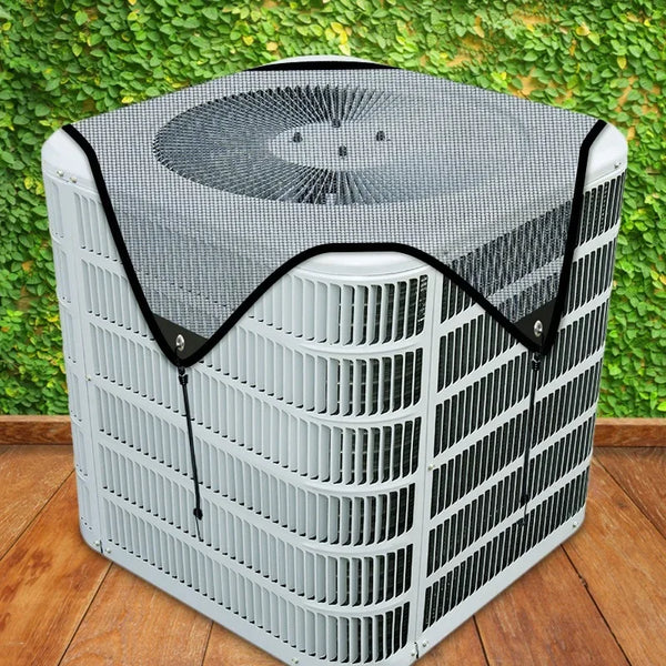 A white outdoor air conditioner unit covered with a black mesh protective cover.