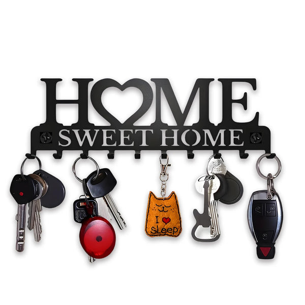 Elegant black metal wall key holder rack with a sign reading HOME SWEET HOME and various keys.