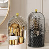 A clear, spherical makeup brush organizer with a lid is shown on a white surface.