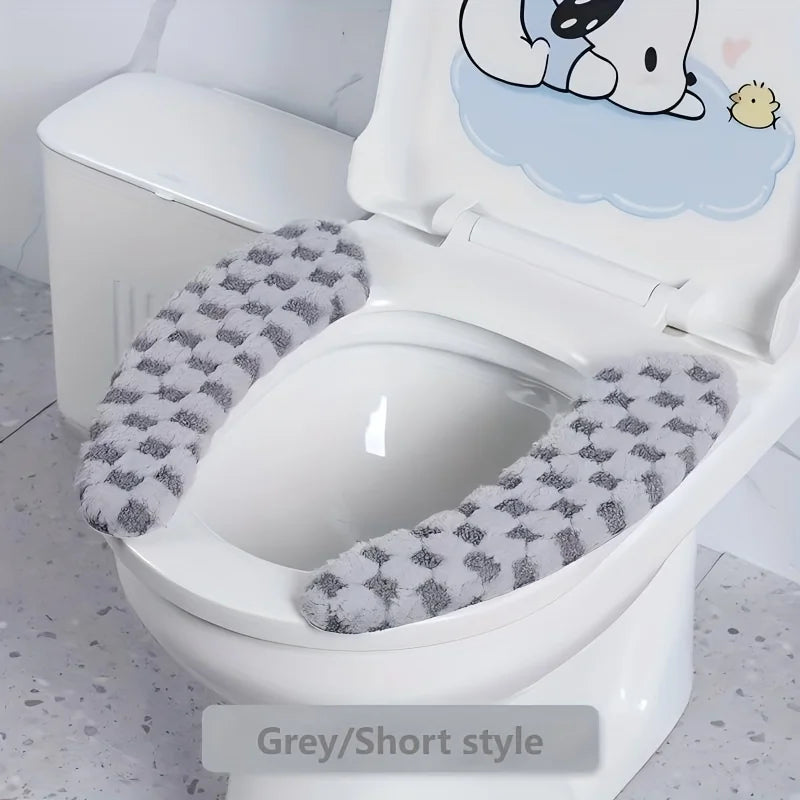 A white toilet features a grey short style seat cushion cover with a cute bear design.
