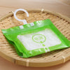 Green plastic bags filled with white moisture absorber material are displayed on a bamboo tray.