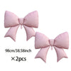 A set of two pink balloon bow decorations for a birthday banner