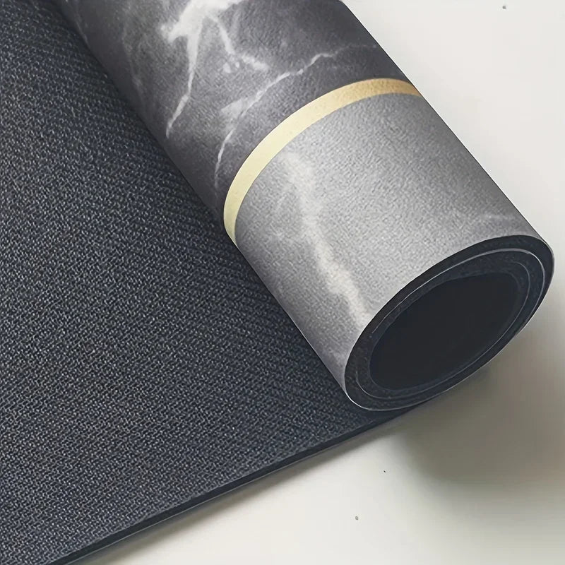 Roll of dark gray diatomite bath mat with a gold accent ring