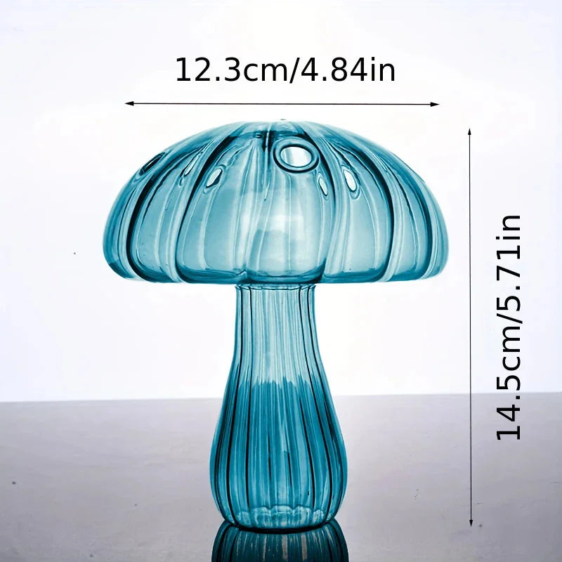 A translucent blue glass mushroom vase with a ribbed stem and dome shape.