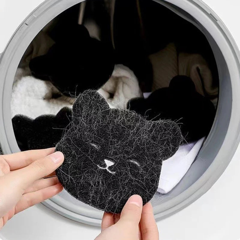 A hand is holding a black pet hair remover sponge, which is being used inside a container filled with pet hair.