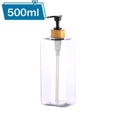 A clear 500ml refillable pump bottle with a wooden cap and a white pump dispenser.