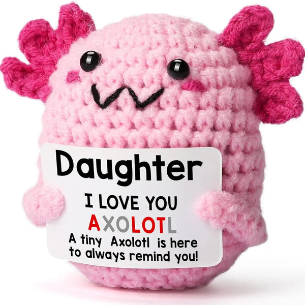 Handmade pink crochet axolotl figurine with black eyes and smiling mouth