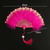 Pink lace fabric folding hand fan with a fluffy pink feather and decorative edge