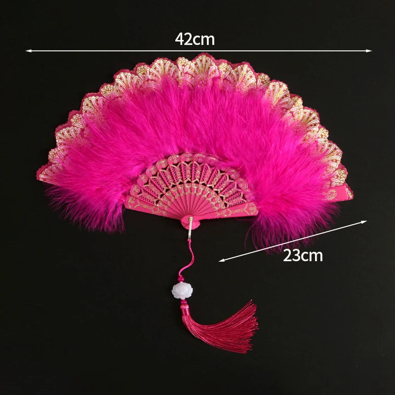 Pink lace fabric folding hand fan with a fluffy pink feather and decorative edge