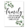 A canvas art print featuring a quote about family surrounded by green leaves and branches.