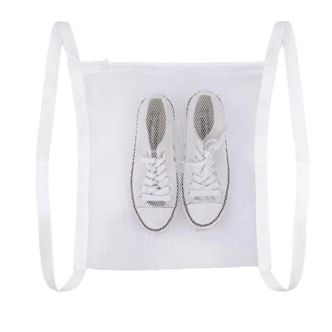White mesh bag with two white sneakers inside, used for portable shoe washing.