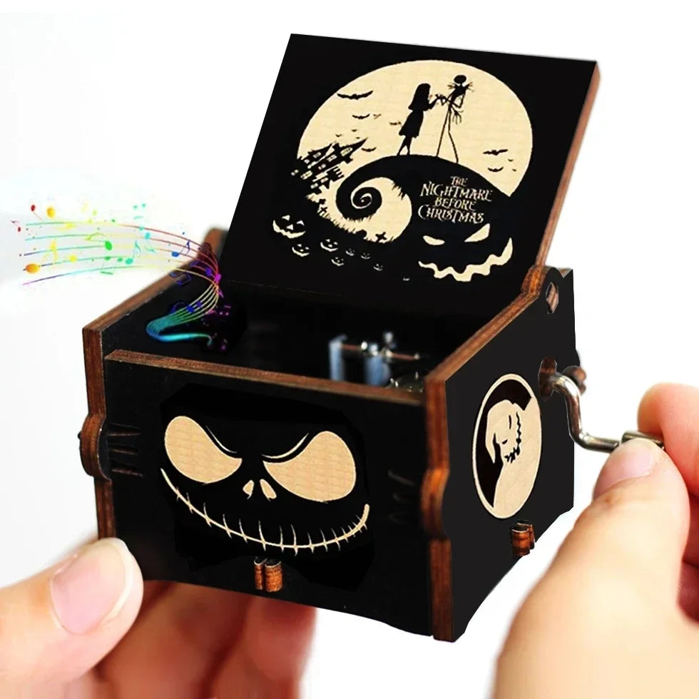 A dark wooden music box with an open lid featuring a skull design and a circular illustration of a witch flying under a moon.