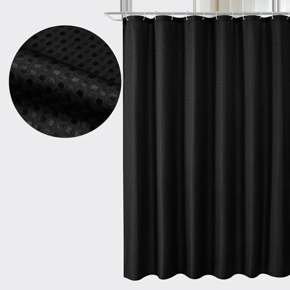 Black waterproof solid color shower curtain hanging from a rod