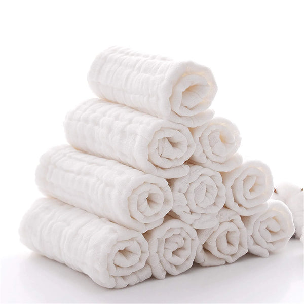 A stack of white rolled natural cotton muslin washcloths.