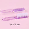 A set of five purple plastic brushes for nail art and dust cleaning displayed on a pink background.