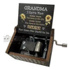 A small wooden music box with a label that reads Grandma I love you more than the stars in the sky and the trees in the fores